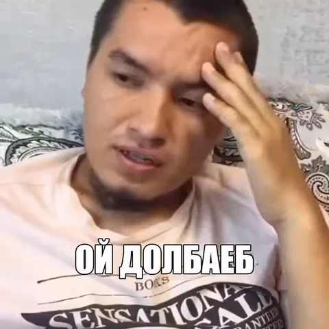 Парень с короткой стрижкой прижимает ладонь к лицу, выражая крайнюю степень усталости или досады. На видео есть надпись «ОЙ ДОЛБАЕБ».