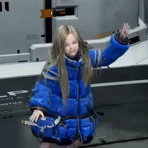 Анимация 3D-девочки в синем пуховике, которая улыбается и машет рукой.