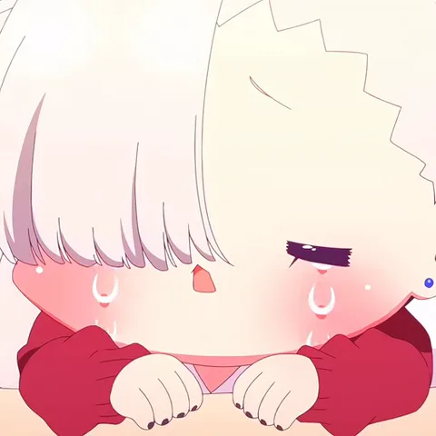 Белокурая девушка в красном свитере плачет навзрыд, положив голову на руки.