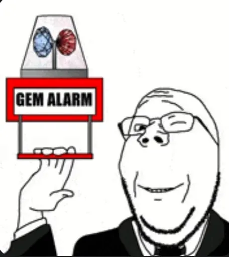 Мужчина в костюме и очках держит устройство с надписью «GEM ALARM» и мигающими огнями.