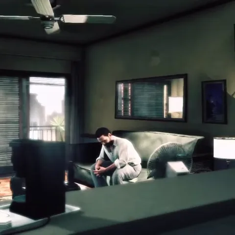 Анимация из игры Max Payne 3: персонаж сидит на диване в тусклой комнате, склонив голову от усталости или печали.