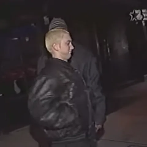 Eminem гуляет и улыбается на камеру.