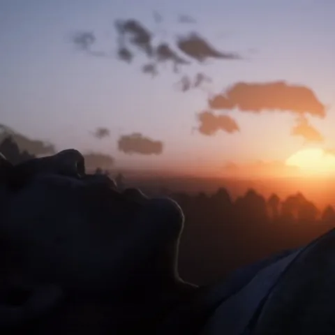 Анимация из игры Red Dead Redemption 2: ковбой лежит на земле и смотрит на красивый оранжевый закат.