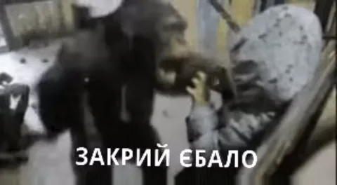 Шимпанзе наклоняется к сидящему человеку и открывает пасть в крике, внизу надпись «ЗАКРИЙ ЄБАЛО».