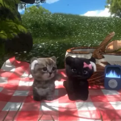 3D-анимация двух котят, сидящих на красной клетчатой скатерти рядом с корзиной для пикника и плеером.